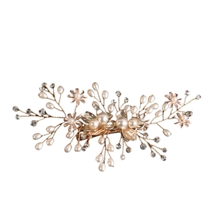 Detail of rose gold bridal hair clip with white pearls and sparkling rhinestones