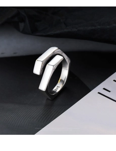 Macro detail of minimalist S925 sterling silver ring showing the geometric wrap design