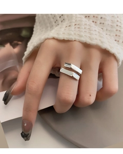 Close-up of a minimalist silver open ring with geometric parallel bar design worn on hand