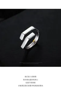 Macro shot of polished S925 sterling silver geometric open ring with inner hallmark stamp