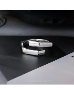Macro shot of minimalist S925 sterling silver open ring with geometric overlapping bars