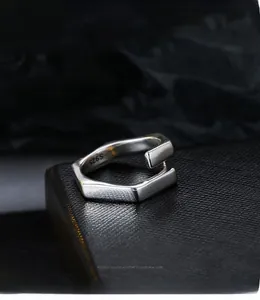 Detailed close-up of S925 silver hexagonal open ring on black leather jewelry box