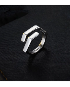 Macro view of geometric S925 silver ring with polished finish and hexagonal design