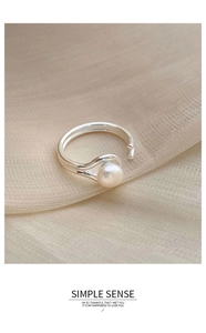 Detailed view of silver double-layered open ring featuring a lustrous white pearl accent