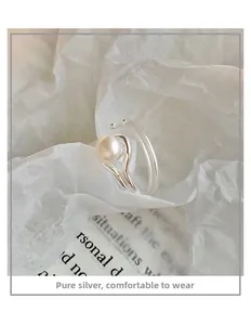 Detail of minimalist double-layered sterling silver ring with a glossy freshwater pearl
