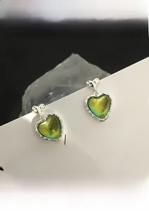 Detailed view of heart-shaped S925 silver stud earring with aurora cat eye stone inlay