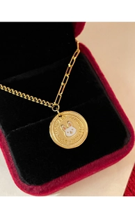 Detail of golden bunny coin pendant necklace with Lucky and Happiness engraving