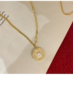 Detailed macro view of gold-plated necklace with double chains and enamel rabbit pendant