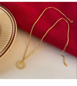 Close-up of golden coin necklace with white rabbit pendant and Good Luck engraving