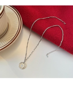 Detail of bunny coin pendant with Good Luck engraving and unique mixed chain necklace