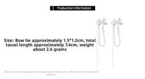 Detailed view of silver bow earrings with zircon stones and long tassel chains