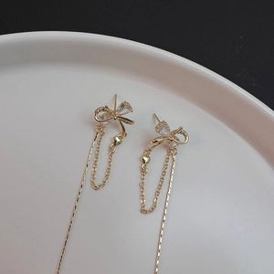 French style gold bow tassel earrings with sparkling crystals for a chic look