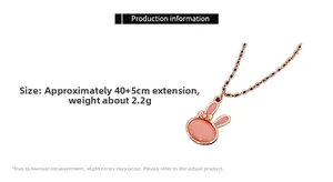 Close-up of pink opal rabbit pendant with rose gold bow and O-chain detailing