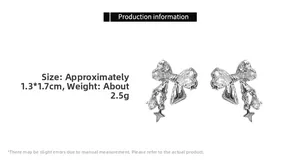 Detail view of sparkling zircon bow earrings with star pendant in silver finish