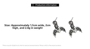 Detail view of gothic heart earrings with crown and bat wings in antique silver