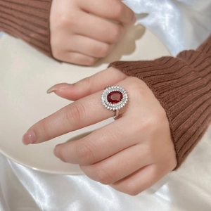 Vintage style sterling silver ring with oval red gemstone and double halo of white zircon