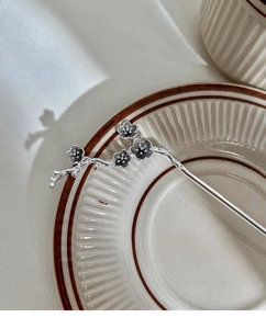 Detailed view of vintage silver plum blossom hair stick with intricate floral branches