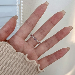 Pink heart-shaped zircon ring for women with silver band and small clear crystals