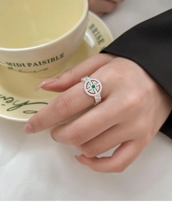 Detail of silver-plated lace ring with green gemstone inlay and pavé zircon settings