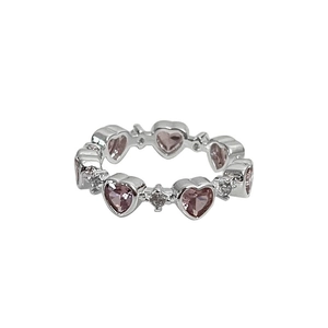 Elegant silver heart ring featuring pink crystals and pavé diamonds on a white background