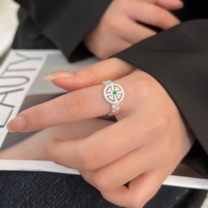 Hetian jade lace braided silver ring with green stone on model's hand with black suit
