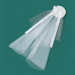 Detailed view of a white bridal veil with elegant satin bow and fine mesh texture