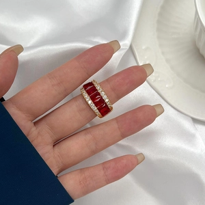 Bague de luxe en or avec cinq rubis rouges rectangulaires et deux rangées de petits diamants