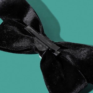 Retro black velvet bow hair clip with metal alligator fastener shown from back angle