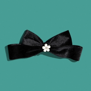 Elegant black velvet bow hair clip with white flower centerpiece and sparkling rhinestone
