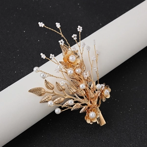 Elegant gold leaf hair clip with pearls and intricate flower design for wedding hairstyles
