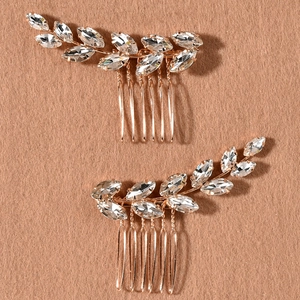 Rose gold bridal hair comb set with marquise crystal leaves on brown velvet background