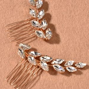 Detailed view of two gold leaf hair combs with sparkling marquise rhinestones for brides