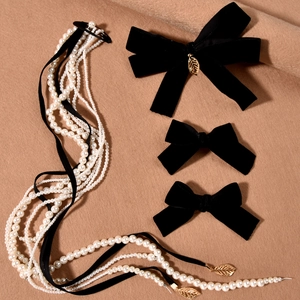 Elegant black velvet bow hair clip set with golden leaf charm and pearl tassel accents