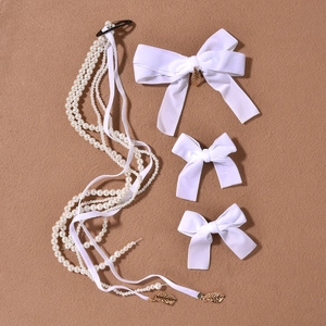 Elegant white velvet bow hair clips set with long pearl tassels and golden leaf pendant