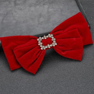 Elegant vintage wine red velvet bow hair clip with crystal buckle on textured background
