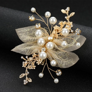 Golden bridal flower hair clip with pearls, rhinestones and mesh on black background