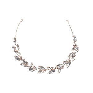 Detail shot of golden bridal headband featuring marquise rhinestone leaf branches