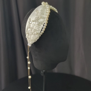 Detail of luxury bridal headband with sequins, pearls and elegant long tassels