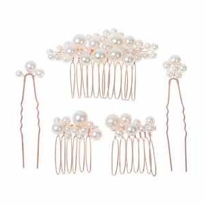 Close-up of 5-piece rose gold bridal hair accessories with pearls and floral wire design