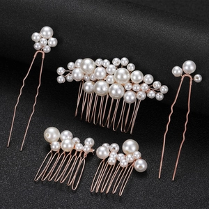 Detailed close-up of handmade rose gold bridal hair combs with elegant white pearls