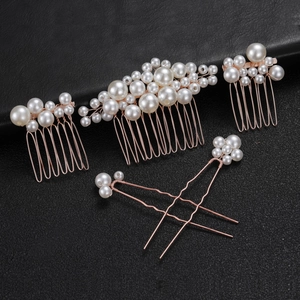 Detailed set of five rose gold bridal hair combs and pins with elegant cream pearls