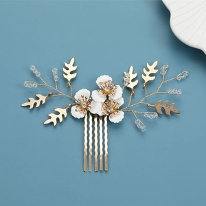 Elegant gold bridal hair comb featuring white flowers, crystal beads and golden leaves