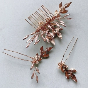 Three-piece bridal hair jewelry set with golden leaves and pearls for wedding hairstyles