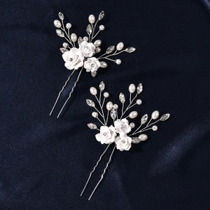 Bridal white clay flower hair pins set with pearls and crystals on blue silk background