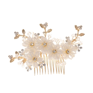 Detail of white beaded flowers and gold leaf bridal hair comb for weddings