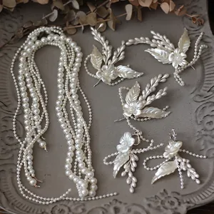 Bridal jewelry set with white pearl flower hair pins and layered necklace accessories