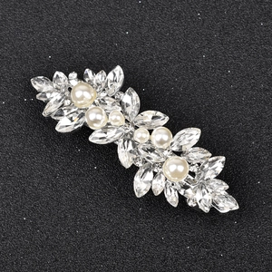 Detailed view of marquise crystal and pearl hair clip with silver alloy floral setting