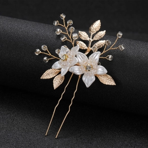 Handmade bridal hair pin with white flowers, gold leaves and crystals on black background