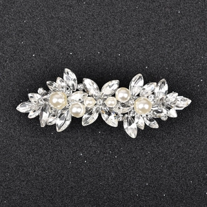 Elegant silver hair clip with marquise crystals and cream pearls on black background
