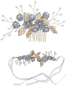 Detailed macro view of blue fabric flowers and golden metal leaves on bridal hair accessories